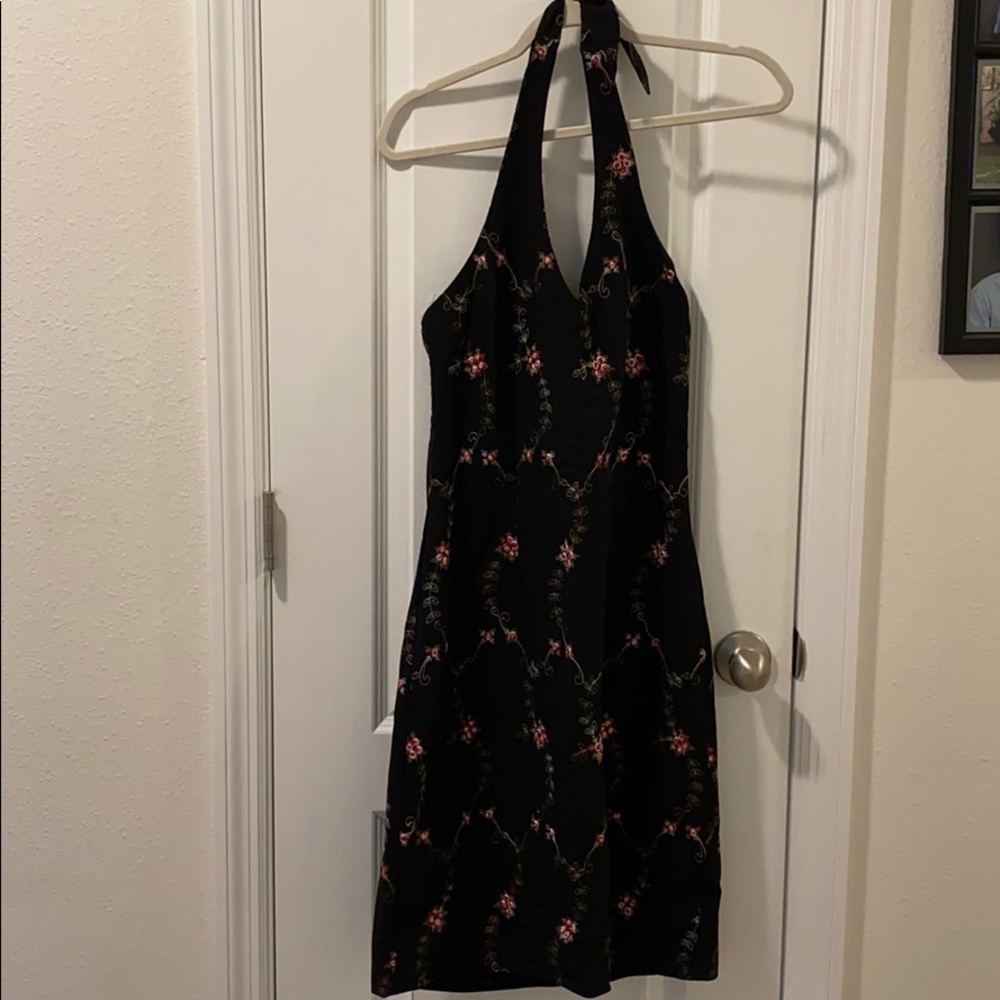 Black dress with pink embroidered flowers.